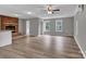 Spacious living room with a brick fireplace, wood floors, large windows, and neutral paint at 332 E Rebound Rd, Lancaster, SC 29720