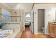 Bathroom with a soaking tub, glass-enclosed shower, and access to the toilet and primary bedroom at 3340 Blue Jay Pass, Fort Mill, SC 29708