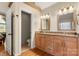 Bathroom with double vanity, granite counters, wood cabinets, and access to the Primary bedroom and toilet at 3340 Blue Jay Pass, Fort Mill, SC 29708
