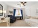 Cozy bedroom featuring a ceiling fan, white closet door, chair, and a window with elegant blue curtains at 3340 Blue Jay Pass, Fort Mill, SC 29708