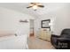 Bright bedroom with a ceiling fan, white furniture, and a gray chair next to a dresser with a mirror at 3340 Blue Jay Pass, Fort Mill, SC 29708