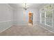 Dining room with view into kitchen, neutral carpet, and chandelier at 3340 Blue Jay Pass, Fort Mill, SC 29708
