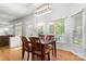 Bright dining area with hardwood floors, a wooden table, and natural light from the windows at 3340 Blue Jay Pass, Fort Mill, SC 29708