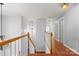 Hallway with wooden staircase and floors, natural light, and white walls at 3340 Blue Jay Pass, Fort Mill, SC 29708