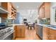 Open-concept kitchen with granite countertops, stainless steel appliances, and view to dining area at 3340 Blue Jay Pass, Fort Mill, SC 29708