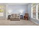 Cozy living room with neutral tones, rocking chair, and natural light at 3340 Blue Jay Pass, Fort Mill, SC 29708