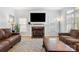 Inviting living room showcasing a marble fireplace with mounted TV and hardwood floors at 3340 Blue Jay Pass, Fort Mill, SC 29708