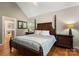 Comfortable primary bedroom with hardwood floors, vaulted ceiling, and natural light illuminating the space at 3340 Blue Jay Pass, Fort Mill, SC 29708