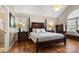 Spacious primary bedroom with hardwood floors, vaulted ceiling, and large windows bringing in plenty of light at 3340 Blue Jay Pass, Fort Mill, SC 29708