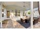 Inviting covered patio with stone floors, ceiling fan, and stylish seating around a fire pit at 3340 Blue Jay Pass, Fort Mill, SC 29708