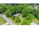 Aerial view of the property surrounded by mature shade trees. The home is centrally located at 3418 Sulphur Springs Ne Rd, Hickory, NC 28601