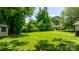 View of the backyard showing green lawn, foliage, and an outbuilding on a sunny day at 3418 Sulphur Springs Ne Rd, Hickory, NC 28601