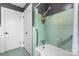 The bathroom features a tub and shower combination with aqua tile, and includes grab bars for added safety at 3418 Sulphur Springs Ne Rd, Hickory, NC 28601