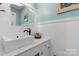 Charming bathroom with blue accent wall, marble countertops, and modern fixtures at 3418 Sulphur Springs Ne Rd, Hickory, NC 28601