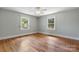 Cozy bedroom featuring neutral colors, hardwood flooring, and natural light from two windows at 3418 Sulphur Springs Ne Rd, Hickory, NC 28601