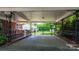 Carport with concrete floor and decorative wrought iron supports has a view of the fenced back yard at 3418 Sulphur Springs Ne Rd, Hickory, NC 28601