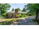 Charming brick home with lush landscaping, chimney, blue shutters and a welcoming driveway at 3418 Sulphur Springs Ne Rd, Hickory, NC 28601