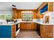 Kitchen boasts custom wood cabinets, contrasting blue drawers, white countertops, and stainless steel appliances at 3418 Sulphur Springs Ne Rd, Hickory, NC 28601