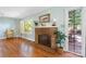 A cozy stone fireplace highlights this warm living room with hardwood floors and bright natural light at 3418 Sulphur Springs Ne Rd, Hickory, NC 28601