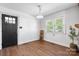 Bright, minimalist living room featuring hardwood floors, black door, and natural light from large window at 3418 Sulphur Springs Ne Rd, Hickory, NC 28601