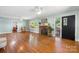 Bright living room with hardwood floors, a stone fireplace, ceiling fans, and large windows with outdoor views at 3418 Sulphur Springs Ne Rd, Hickory, NC 28601