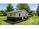 Exterior view of the outbuilding with partial siding and a dark green painted base at 3418 Sulphur Springs Ne Rd, Hickory, NC 28601