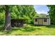View of the chicken coop and a storage building sitting on a lush green lawn surrounded by mature shade trees at 3418 Sulphur Springs Ne Rd, Hickory, NC 28601