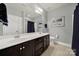 Bathroom featuring a double sink vanity with dark wood cabinets, a shower, and tile floors at 3426 Richards Xing, Fort Mill, SC 29708
