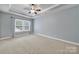 Bright bedroom with tray ceiling, ceiling fan, and a large window with natural light and a view at 3426 Richards Xing, Fort Mill, SC 29708