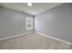 Empty bedroom featuring neutral carpet, a ceiling fan, and a window with blinds at 3426 Richards Xing, Fort Mill, SC 29708