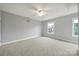 Empty bedroom featuring neutral carpet, a ceiling fan, and natural light from the windows at 3426 Richards Xing, Fort Mill, SC 29708