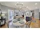 Open-concept dining room with elegant chandelier, hardwood floors, and views of the living room at 3426 Richards Xing, Fort Mill, SC 29708