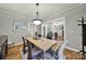Inviting dining room featuring a light wood table, classic chandelier, and gray walls at 3426 Richards Xing, Fort Mill, SC 29708