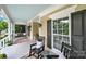 Inviting front porch featuring rocking chairs, a porch swing, and a tranquil view of the surrounding landscape at 3426 Richards Xing, Fort Mill, SC 29708