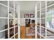 Bright home office showcasing hardwood floors, classic furniture, and natural light through glass doors at 3426 Richards Xing, Fort Mill, SC 29708