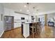 Modern kitchen island with white cabinetry, wooden chairs, and stainless steel appliances at 3426 Richards Xing, Fort Mill, SC 29708