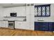 Modern kitchen with white and blue cabinets, stainless steel appliances, and hardwood floors at 3426 Richards Xing, Fort Mill, SC 29708