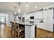 Bright kitchen island with granite countertops, wooden chairs, and modern lighting at 3426 Richards Xing, Fort Mill, SC 29708