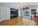 Spacious living room featuring a large TV, hardwood floors, and access to the patio at 3426 Richards Xing, Fort Mill, SC 29708