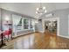 Bright living room featuring hardwood floors, large windows, and a view of the dining room at 3426 Richards Xing, Fort Mill, SC 29708