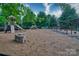 A large playground area with slides, swings, and climbing structures, surrounded by trees and soft ground cover at 3426 Richards Xing, Fort Mill, SC 29708