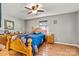 Bedroom with wood floors featuring a bright blue flower pattern comforter and light wood furniture at 3690 Birchwood Ln, Denver, NC 28037