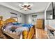 Spacious bedroom with wood floors featuring a bright blue flower pattern comforter and light wood furniture at 3690 Birchwood Ln, Denver, NC 28037