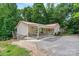 Inviting home with a covered porch, red roof, lush greenery, and easy access with parking at 3690 Birchwood Ln, Denver, NC 28037