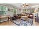 Cozy living room features leather sofas, patterned rug, and natural light from windows at 3690 Birchwood Ln, Denver, NC 28037