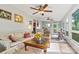 Bright and cozy living room featuring ceiling fans, neutral walls and flooring leading to a sunroom at 3690 Birchwood Ln, Denver, NC 28037