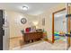 A cozy office space with a wooden desk, tile flooring, and a nearby playroom at 3690 Birchwood Ln, Denver, NC 28037