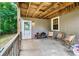 Covered porch with seating and decor, offering a relaxing outdoor space at 3690 Birchwood Ln, Denver, NC 28037