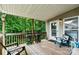 Relaxing covered porch offers chairs and a view of the lush, green surrounding forest at 3690 Birchwood Ln, Denver, NC 28037