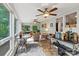 Sunroom with multiple ceiling fans, multiple sitting areas, and large windows at 3690 Birchwood Ln, Denver, NC 28037